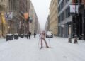 Woman skiing in Soho in a snowstorm in New York