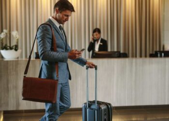 Man looking at his Hotel Bill for Resort Fees on his phone