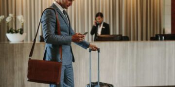 Man looking at his Hotel Bill for Resort Fees on his phone