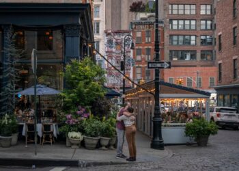 Couple hugs on the corner in SoHo