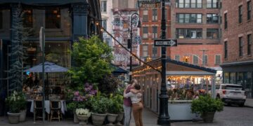 Couple hugs on the corner in SoHo